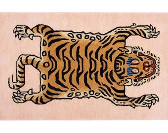 May include: A pink rug featuring a brown and black tiger design. The tiger is lying on its back with its paws raised in the air. The tiger's eyes are blue and its mouth is open.