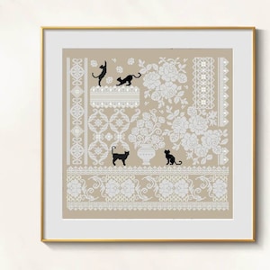May include: Cross-stitch artwork with a beige backdrop, adorned with white floral and lace patterns. Black cat silhouettes are playfully arranged throughout the design. The artwork is presented in a gold-coloured frame.