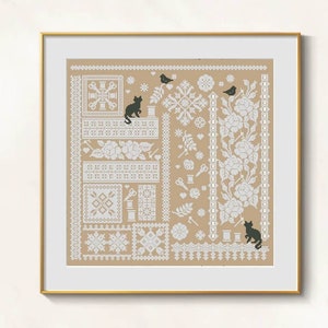 May include: Framed cross-stitch sampler with a beige background and white floral and geometric patterns. Black cat and bird silhouettes are scattered throughout the design. The sampler is in a gold frame.