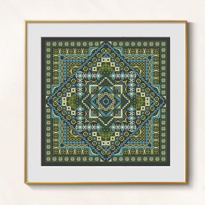 May include: A framed cross-stitch piece featuring a geometric design in shades of green, blue, and yellow. The intricate pattern is centered within a dark border and framed in gold. The artwork showcases a detailed, symmetrical design.