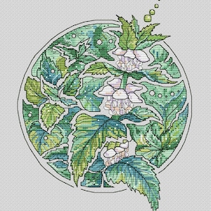 May include: Cross-stitch pattern featuring a botanical design within a circular frame. The artwork showcases a variety of green leaves and delicate white flowers, with a detailed, textured appearance. The design is set against a white background.