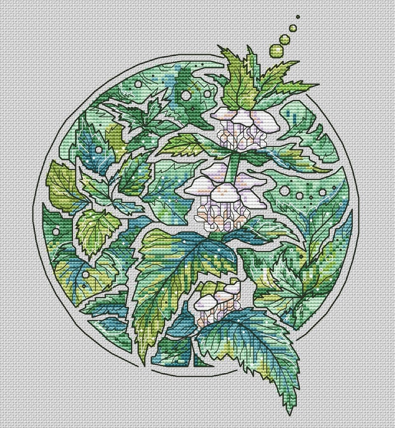 May include: Cross-stitch pattern featuring a botanical design within a circular frame. The artwork showcases a variety of green leaves and delicate white flowers, with a detailed, textured appearance. The design is set against a white background.
