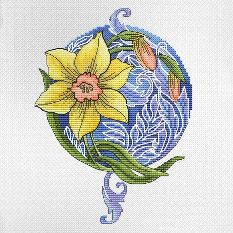 May include: A cross-stitch design featuring a yellow daffodil with a pink center, set against a blue background with white floral accents. Green leaves and a decorative blue swirl complete the floral pattern.
