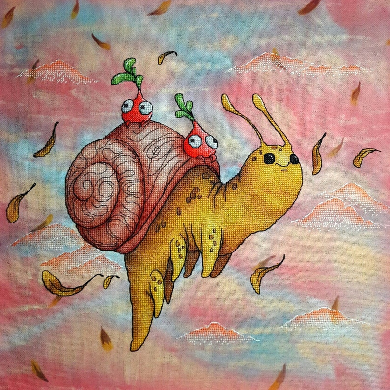 May include: A cross-stitch image of a yellow snail with a spiral shell, carrying two red radish-like creatures. The background is a pastel sky with clouds and falling leaves, creating a fantasy scene.