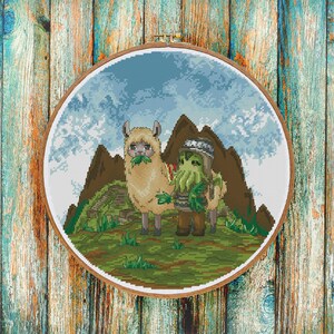 May include: Cross-stitch embroidery in a wooden hoop. The design features a llama eating leaves next to a creature with tentacles, both standing in front of a mountain range. The background is a blue sky with clouds.