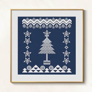 May include: A framed cross-stitch design featuring a white Christmas tree and star accents on a navy blue background. The design includes decorative borders with snowflake and star patterns, creating a festive holiday theme.