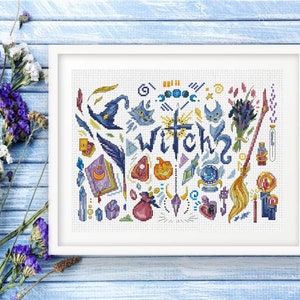 May include: A framed cross-stitch design featuring witch-themed elements. The design includes a witch hat, cats, a broom, a spell book, and the word "WITCH" in the center. The color palette includes blue, purple, orange, and yellow.