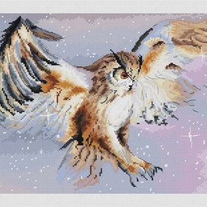 May include: Cross-stitch artwork of a Eurasian eagle-owl in flight. The owl has brown, white, and black feathers, with outstretched wings. The background is a gradient of light blue and pink, with white dots suggesting snowfall. The owl's orange eyes are focused.