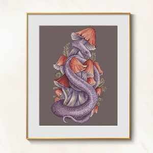 May include: Framed cross-stitch art featuring a purple snake coiled around a cluster of mushrooms with red and orange caps. The artwork is set against a gray background and framed in gold.
