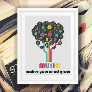 May include: Cross-stitch art in a white frame. The design features a tree made of vinyl records in various colors. The trunk and branches are colorful lines. The text "MUSIC makes your mind grow" is below the tree.
