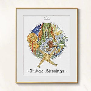 May include: Framed artwork with a circular design, featuring a central figure and symbolic imagery. Includes a straw cross, candles, and the text "~ Imbolc Blessings ~". The colour palette includes greens, blues, and yellows.