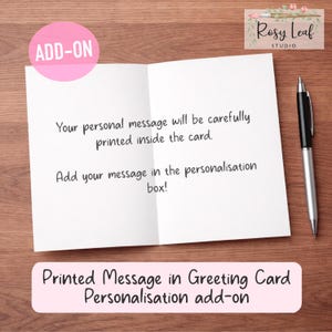May include: A white greeting card, open to reveal printed text, with a black pen and a pink add-on label. The card states, "Your personal message will be carefully printed inside the card." and "Add your message in the personalisation box!"