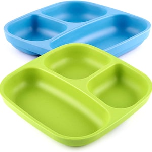 May include: Two divided plates, one light blue and one green, are stacked. Each plate has three compartments. The plates are made of a smooth, solid material. The design is simple and functional, suitable for serving meals.