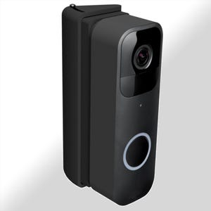 Może przedstawiać: Czarna kamera do wideodomofonu z szerokokątnym obiektywem i okrągłym przyciskiem. Kamera jest zamontowana na ścianie.