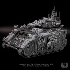 May include: A gray plastic miniature tank model featuring intricate gothic architectural details, including arched windows, sculpted figures, and chain embellishments. The tank is equipped with a turret-mounted cannon and side-mounted weaponry.