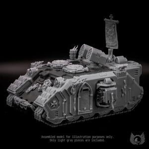 May include: A light gray plastic miniature tank model featuring a top-mounted banner, dual missile launchers, and intricate armor plating with cross emblems. The vehicle includes side doors, tread tracks, and hatch details on the upper deck.