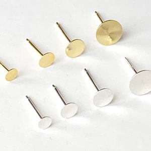 May include: Assortment of earring blanks in gold and silver. The blanks are round and come in various sizes.