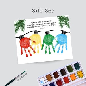 May include: A white print with colorful handprint light bulbs, each a different color: red, yellow, green, and blue. The print includes the text "I AM THE LIGHT OF THE WORLD..." and is 8x10 inches in size. A watercolor paint set and brush are in the image.