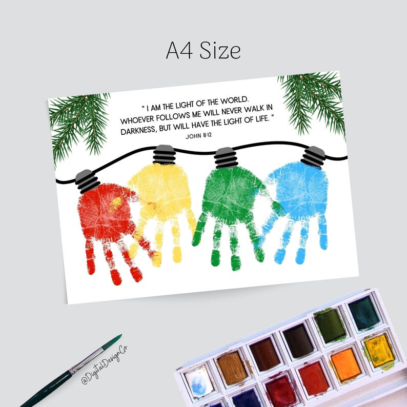May include: A4 size print featuring colorful handprints shaped like Christmas lights. The print includes the text "I AM THE LIGHT OF THE WORLD..." from John 8:12. A watercolor palette and paintbrush are in the image.