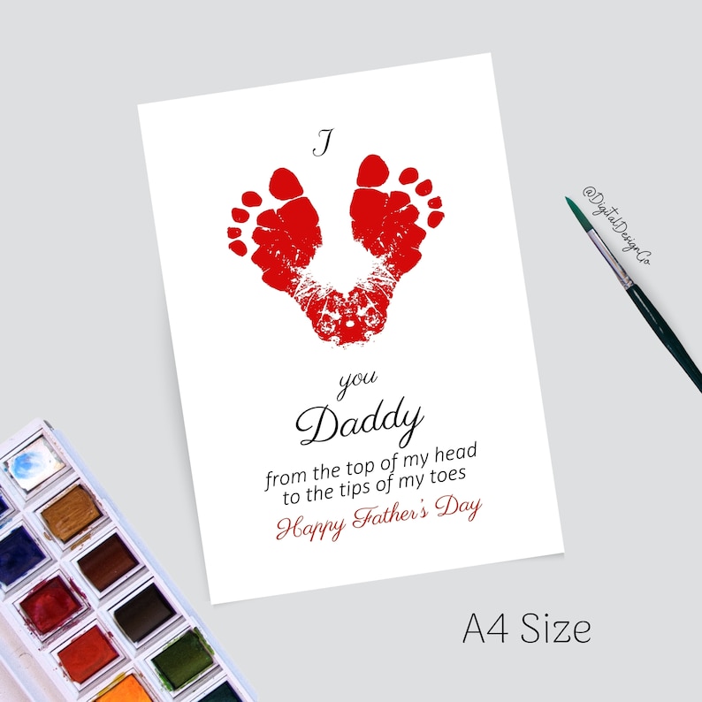 May include: A white card with red handprints in the shape of a heart. The card reads "J you Daddy from the top of my head to the tips of my toes Happy Father's Day".