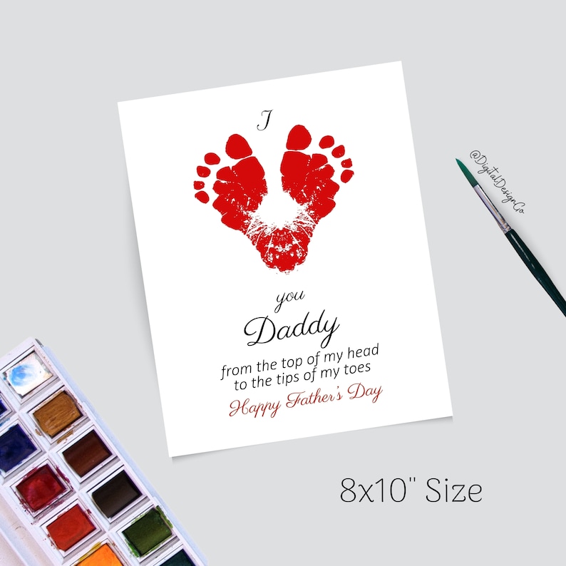 May include: A white card with red handprints in the shape of a heart. The card reads "I you Daddy from the top of my head to the tips of my toes Happy Father's Day". The card is 8x10 inches.