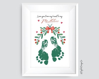 May include: A white frame with a white background and green footprints. The footprints are under a green and red mistletoe with the text "Love you from my head to my mistletoes".