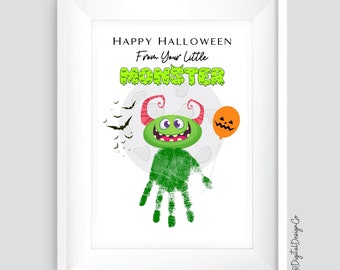 May include: A framed Halloween print featuring a green monster made from handprints, holding an orange jack-o'-lantern balloon. The text reads "Happy Halloween From Your Little Monster" with bats and a full moon in the background.