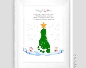 May include: A framed Christmas print featuring a green footprint Christmas tree topped with a gold star. The print includes the text "Merry Christmas" and a poem. Santa and a reindeer are at the bottom of the print.