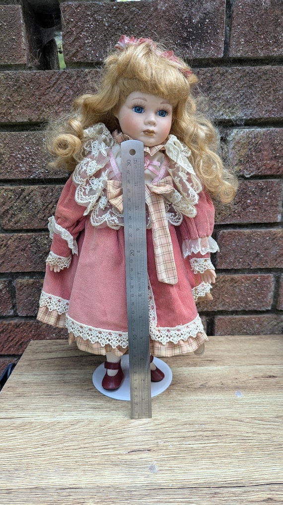 Leonardo Collection “rebecca” Porcelain Doll in Pink Corduroy