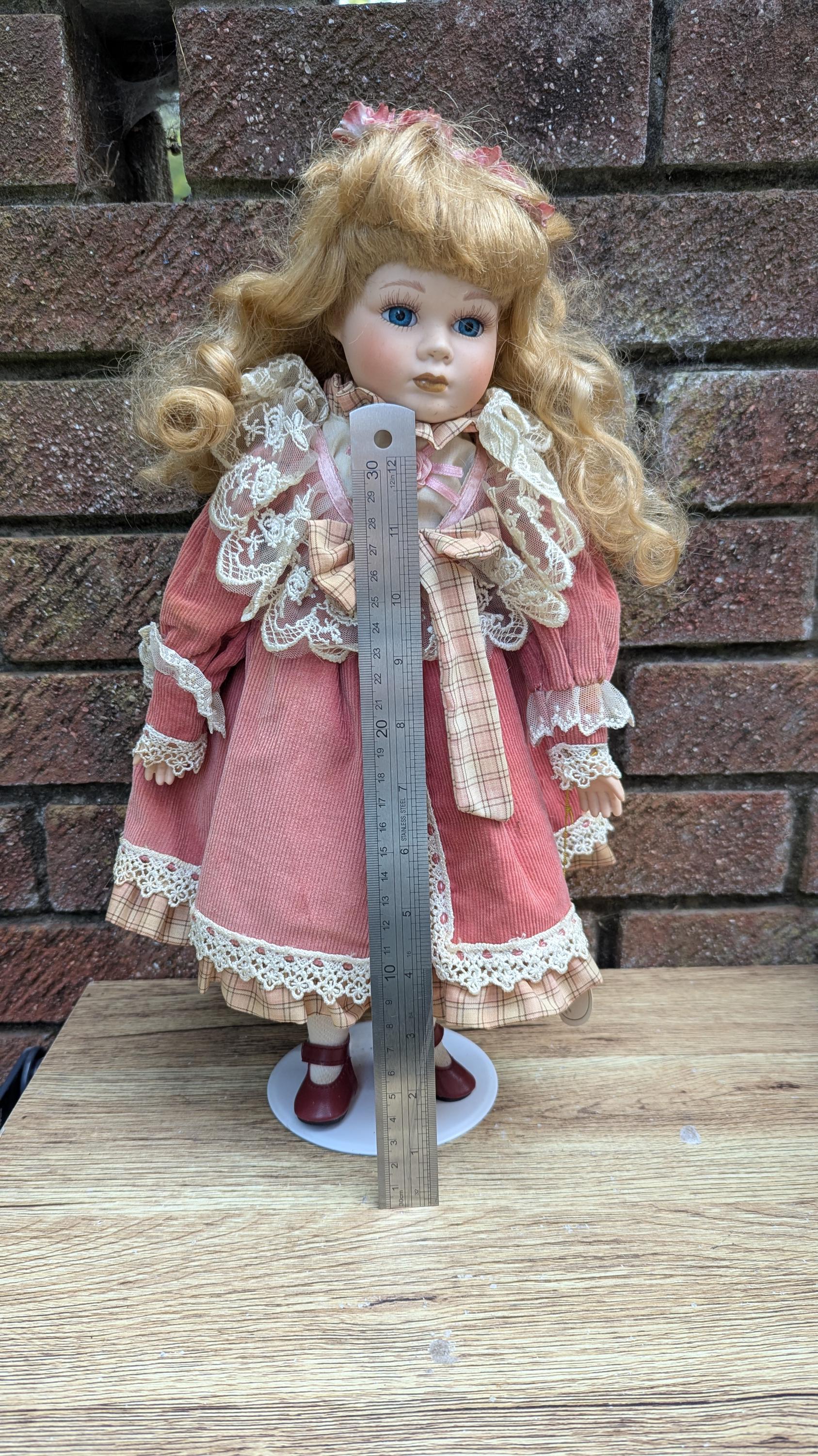 Leonardo Collection “rebecca” Porcelain Doll in Pink Corduroy