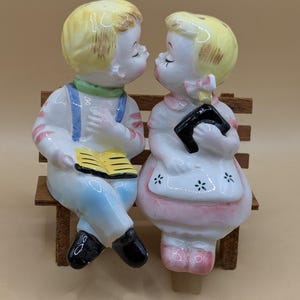 1950s Kissing Boy and Girl Sitting on A Wooden Bench, Salt Pepper