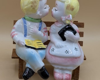 1950s Kissing Boy and Girl Sitting on A Wooden Bench, Salt Pepper