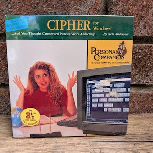 May include: A vintage software box for Cipher for Windows by Nels Anderson. The box features a person with long curly hair, a computer monitor displaying a word puzzle game, and a yellow circular sticker indicating one 3.5 inch disk inside.