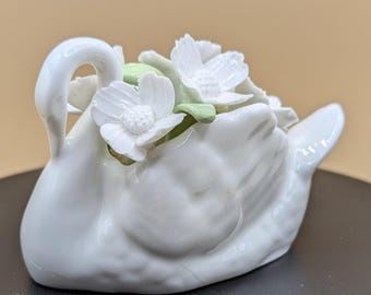 Ceramic Swan with White Flowers in its back, Posie Gilder with Ceramic Flowers with Green leaves.