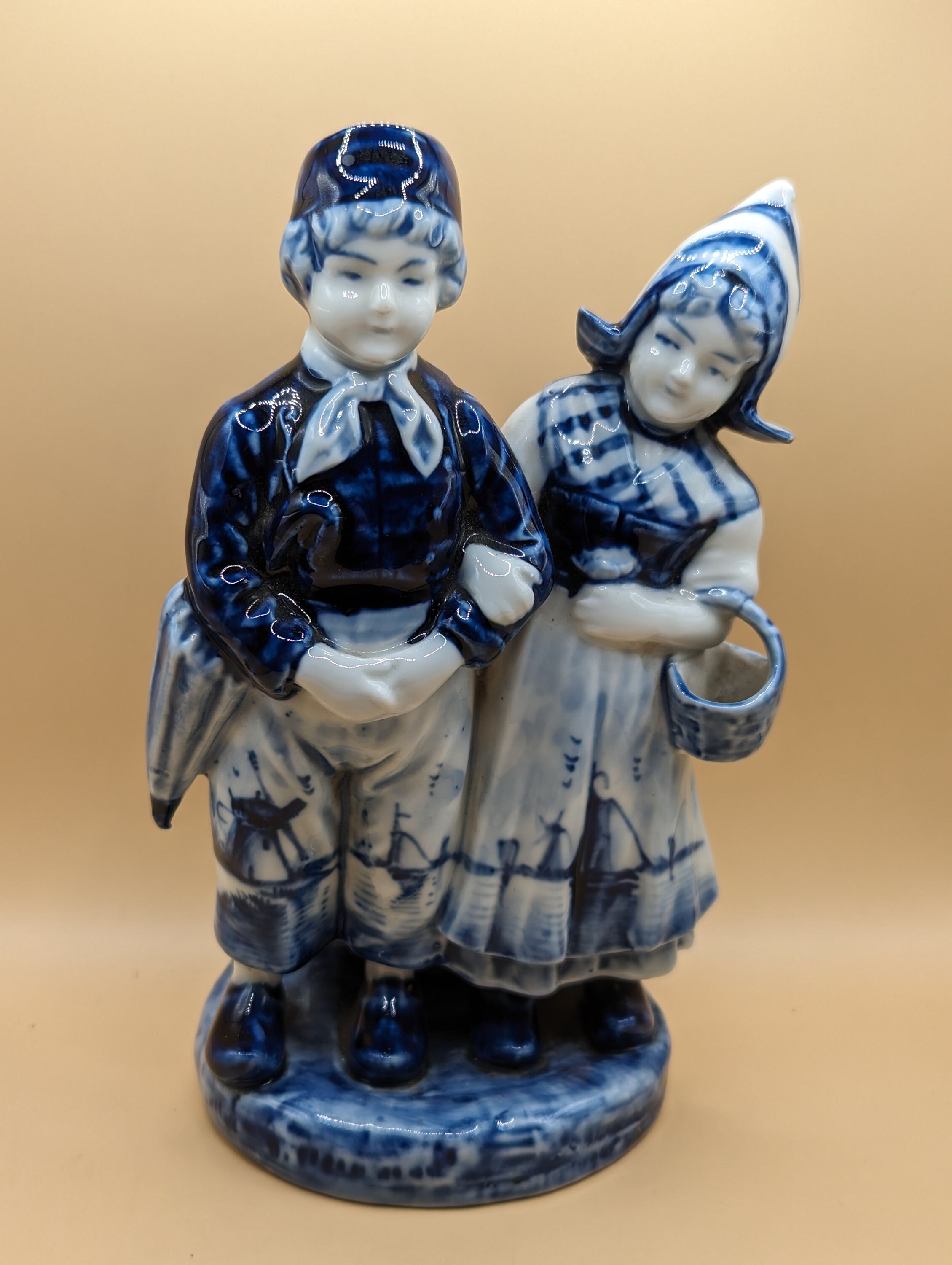 A Delft Blue and White Spill Holder Figurine With Two Happy