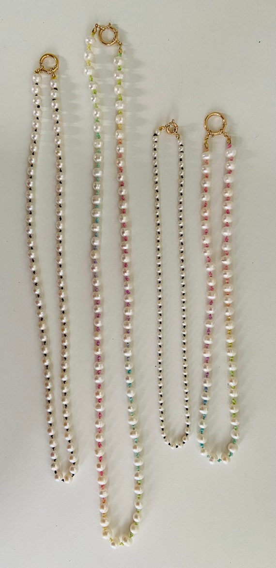 Hand knotted Freshwater Pearl necklace on colorful silk string with 14k solid gold sailor clasp. Available sterling silver and gold filled.