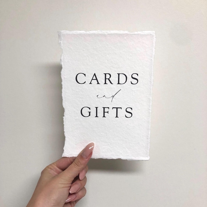 May include: White card with black text that reads "CARDS and GIFTS".