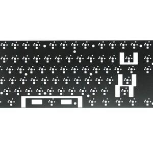 May include: Black metal keyboard plate with white cutouts for key switches. The plate has a rectangular shape and is designed for a 60% keyboard layout.