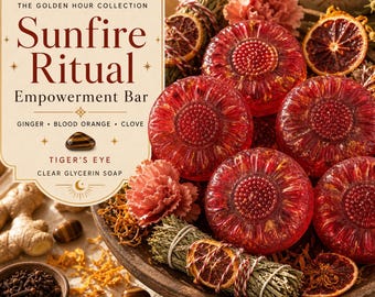 May include: A collection of round, translucent red glycerin soap bars with textured centers, arranged with dried orange slices, sage bundles, ginger root, whole cloves, and tiger's eye stones. The label reads The Golden Hour Collection Sunfire Ritual Empowerment Bar Ginger Blood Orange Clove Tiger's Eye Clear Glycerin Soap.