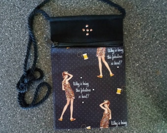 May include: Black crossbody bag with a zipper closure and a black strap. The front of the bag features a black fabric with a repeating pattern of a woman in a dress and the text "Why is being this fabulous so hard?"