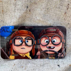 May include: A white ceramic mug with a black handle and the text "But First, Coffee" in a black, bold font. The mug is sitting on a white surface.