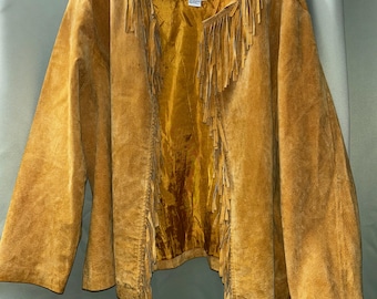 May include: A mustard yellow suede jacket featuring long fringe detailing along the front opening and neckline. The jacket has long sleeves, an open front design, and a matching mustard yellow interior lining with a visible brand label at the neck.