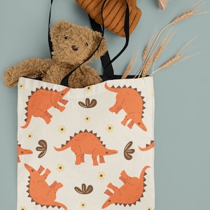Orange Dinosaur Tote Bag Fun Fierce Dino Themed Carryall for Kids Prehistoric Style and Adventure Dinosaur Lovers Gift Bag Cool Library Tote