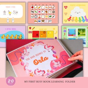 May include: A children's learning folder with multiple educational pages. The cover is decorated with unicorns and stars and reads "This book belongs to Orla". Other pages include an alphabet chart, "Today I Feel", and "5 Little Ducks".