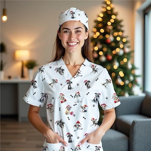 May include: White medical scrubs and matching cap featuring a repeating pattern of dogs wearing Santa hats, paw prints, and bones. The scrubs have a V-neck and short sleeves. The person is smiling.
