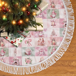 May include: A festive Christmas tree skirt with a patchwork design in pink and green squares. The skirt is trimmed with a white fringe and features illustrations of gnomes, houses, and candy canes. A Christmas tree and wrapped gifts are on top.