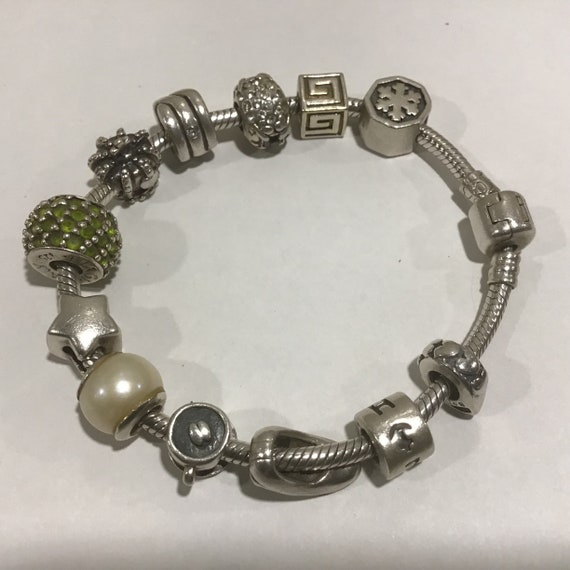 925 Sterling Silver Charm Bracelet Carlo Biagi With 12 Charms. Some of the charms are marked Biagi 925 Sterling Silver. Made in Italy