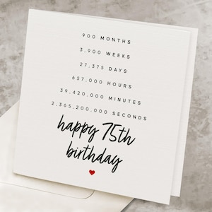 May include: A white birthday card with black text that reads "happy 75th birthday" and a red heart. The card lists the equivalent time in months, weeks, days, hours, minutes, and seconds.