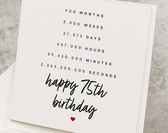 May include: A white birthday card with black text that reads "happy 75th birthday" and a red heart. The card lists the equivalent time in months, weeks, days, hours, minutes, and seconds.