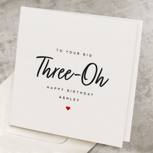 May include: White card with black text that reads "To your big Three-Oh Happy Birthday Ashley" with a small red heart at the bottom.